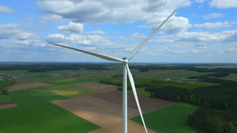 Close-up-shot-of-a-wind-turbine's-three-blades-slowly-rotating-as-the-camera-slowly-flies-away,