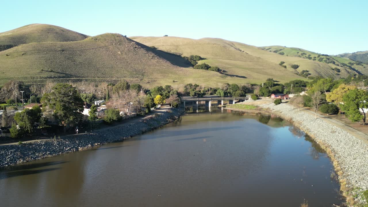 Aerial view zooming in on the Stanley Bridge in Fremont California, capturing the roadway and the area it seamlessly connects.