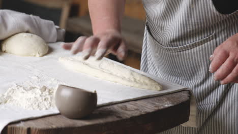 georgian shotis puri being prepared and pressed against the tone wall