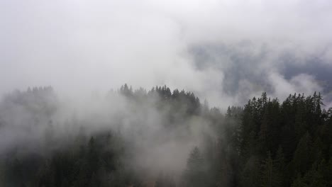 dramatic low clouds obscure the valley floor in the mountains of the alps