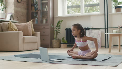 girl doing online yoga at home