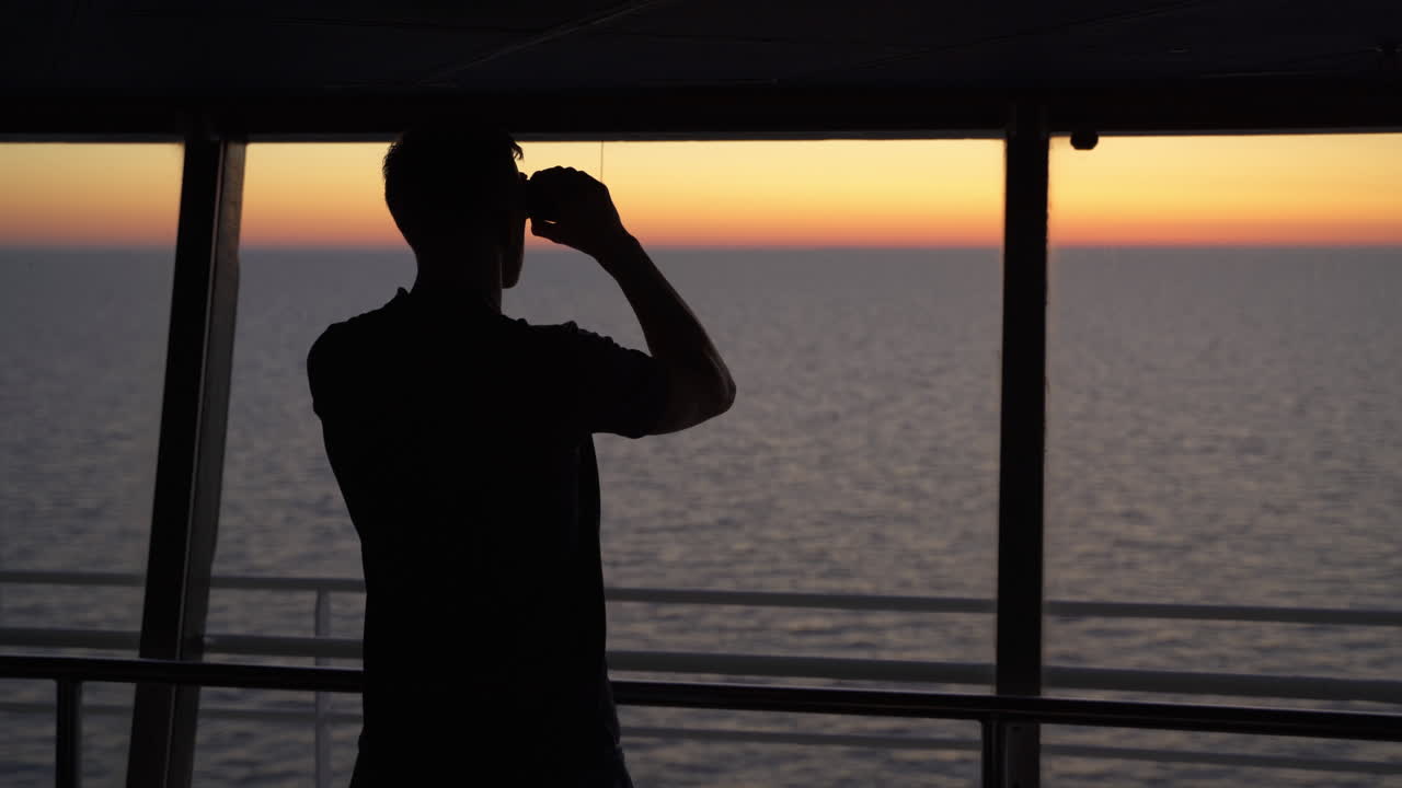 Silhouette of navy captain looking seascape sunset with a binocular, cinematic