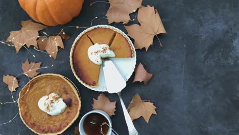 4k seamless loop of pumpkin pie flat lay and lights twinkling.