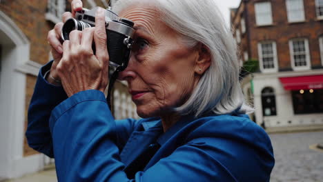 elderly woman taking photos with a vintage camera on a city street