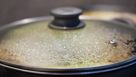 close-up of a covered pot with steam