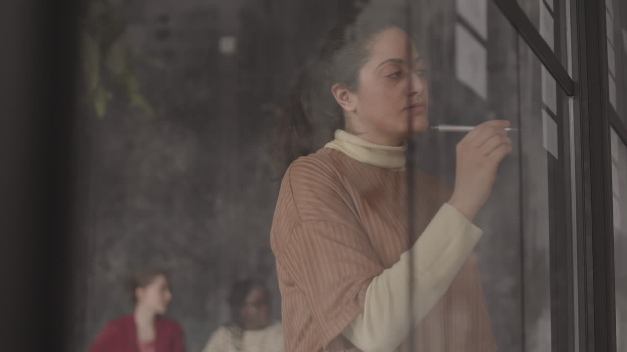 Pensive Mixed-Race Woman Behind Glass Wall