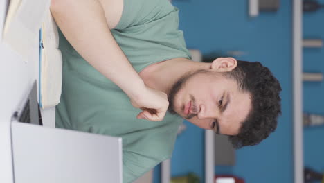 Vertical-video-of-Male-student-doing-research.