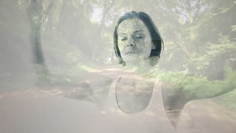 composición digital de mujer caucásica meditando contra la vista del camino del bosque
