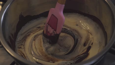 adding heavy cream into caramel mixture while stirring