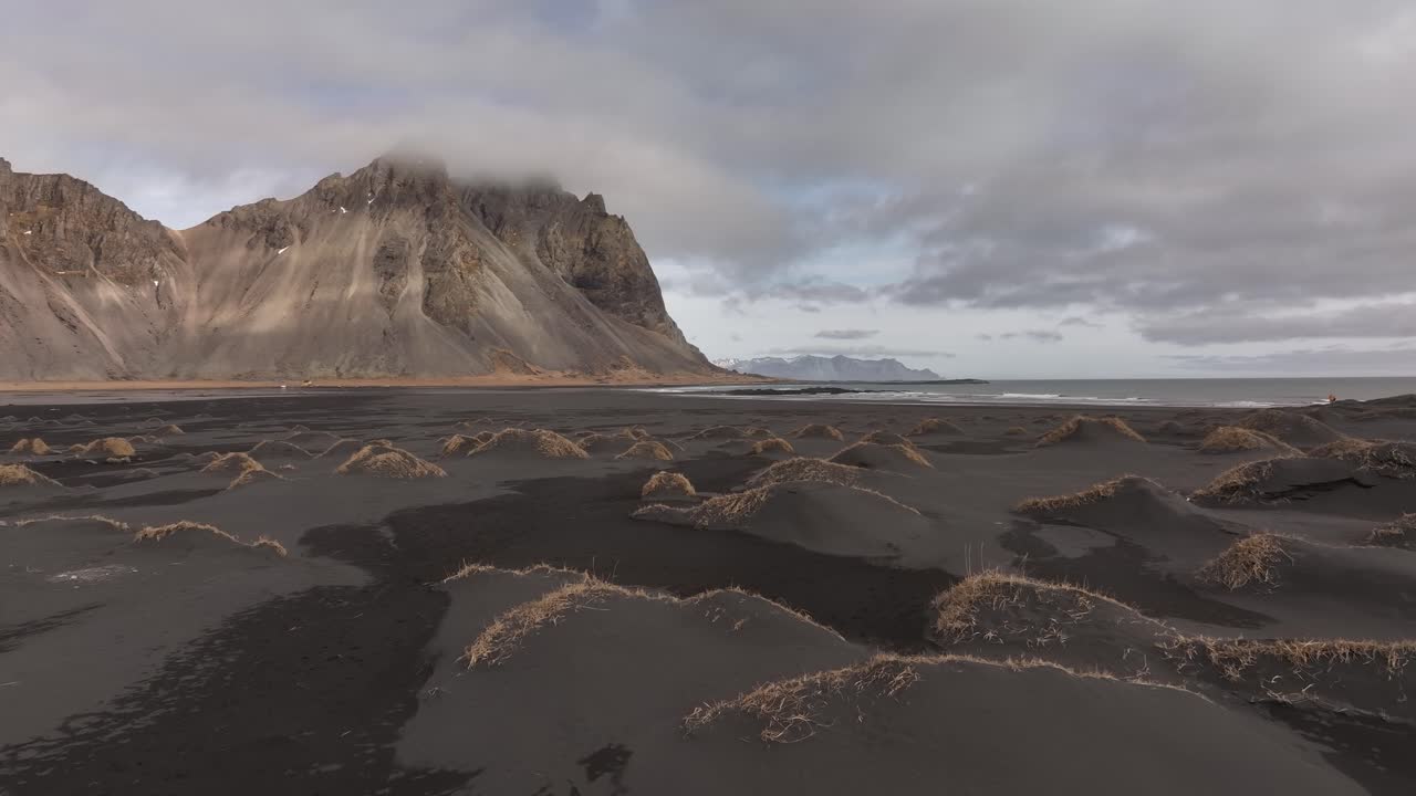 Vestrahorn mountain range seen from the sea. Iceland in all its beauty on a dramatic evening with clouds