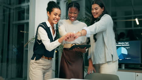 businesswomen collaborating and celebrating success in the office