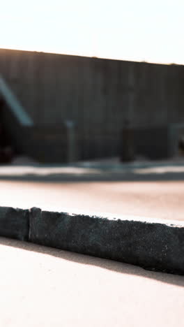 close-up of a concrete curb with a shadow on the pavement