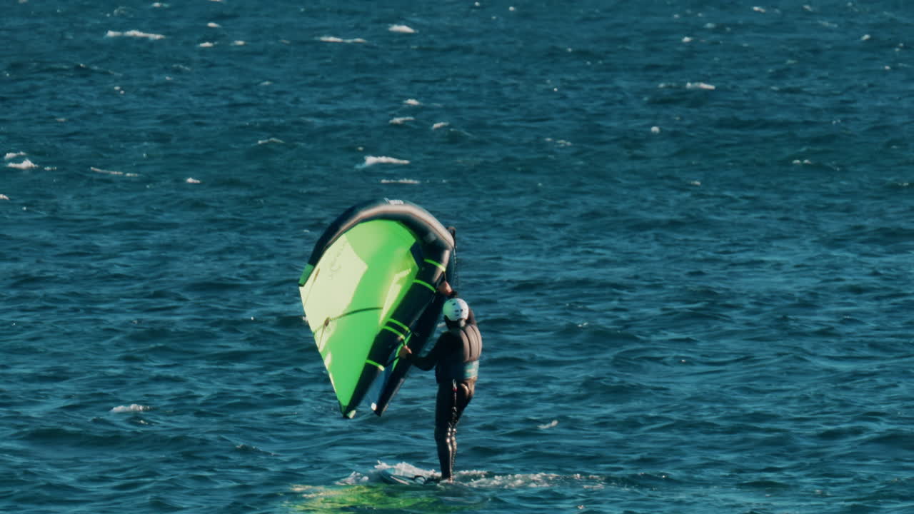 Vallauris, France - October 18, 2024: Man practicing wing surfing on the sea