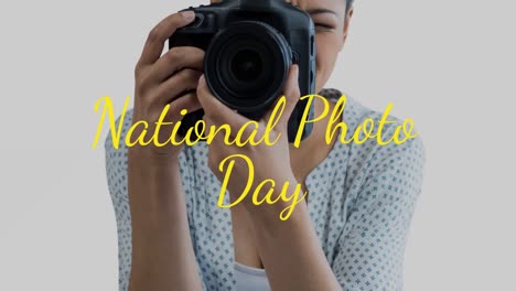 animation of caucasian woman holding camera over national photo day text