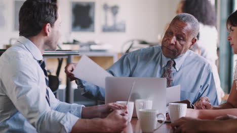 business team having informal meeting around table in coffee shop