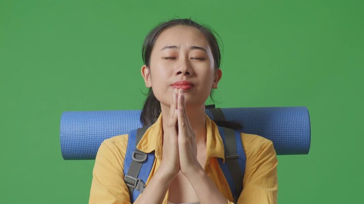 Woman Praying with Backpack