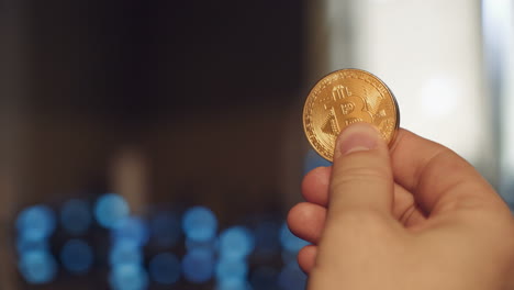 Golden Bitcoin in a man hand. Concept of mining. Electronic virtual money. Symbol of investment in cryptocurrency.