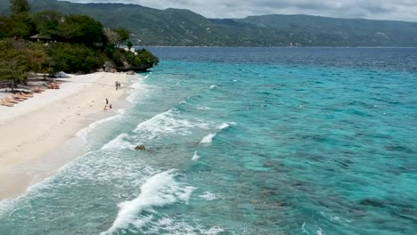 drone footage of crystal clear blue water and waves on the shore of beach in cebu philippines-15