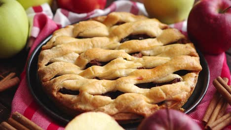 homemade pastry apple pie with bakery products on dark wooden kitchen table