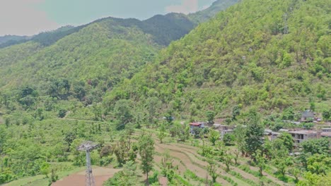 a cable car moves smoothly across a lush green mountain landscape, offering a scenic view of nature and hillside terrain. ideal footage for travel, tourism, transportation, and eco-adventure themes