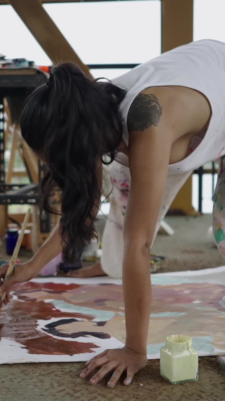 Artist painting on the floor