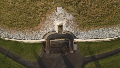 newgrange monument in ireland glows with golden sunlight at sunrise above the river boyne