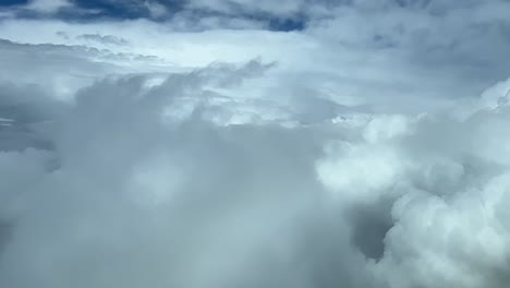 awesome view from a jet’s cockpit: flying though a turbulent sky full of cumulus