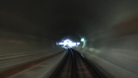 train speeding through a dark tunnel with bright lights