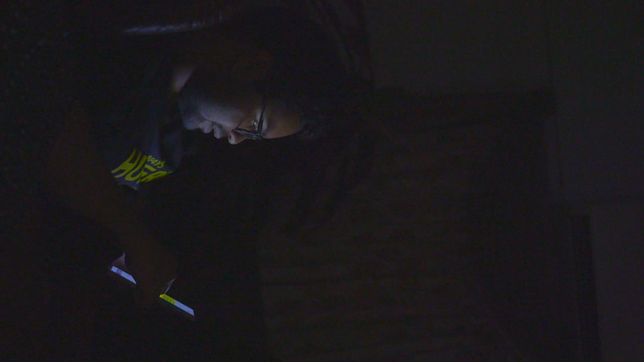Person using phone in the dark