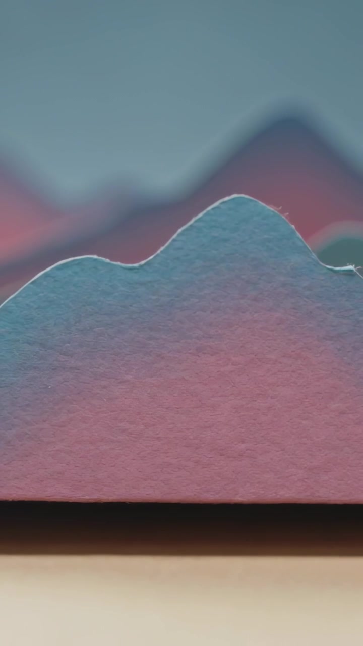 Vertical video: Zooming camera revealing torn paper ridge on tabletop to show fibers, gradient