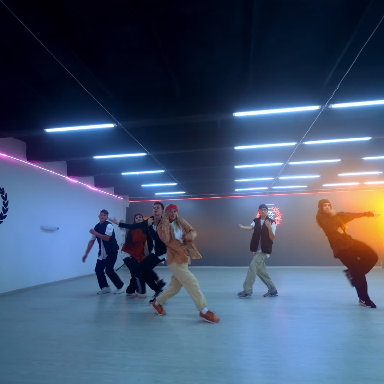 Mixed boys and girls band dancing hip hop. Young people active lifestyle. Dance studio backdrop
