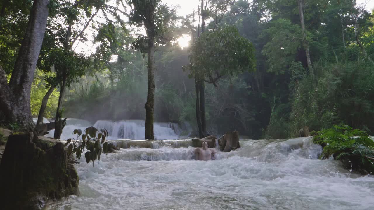 Man Relaxing With Deep Waterfall, Slow Motion