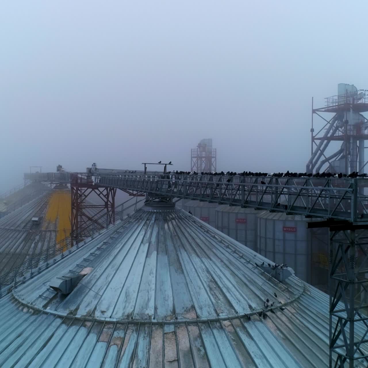 Metal grain elevator construction. Big industrial elevator containers aerial view