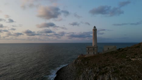 otranto, puglia, italy - tourists visiting faro palascia, with views of the sea at sunset - pan up shot