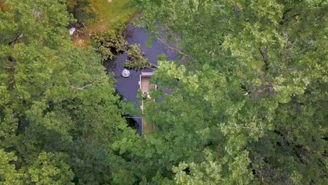 Aerial-revealing-view-of-wedding-couple-on-wooden-bridge-in-pond