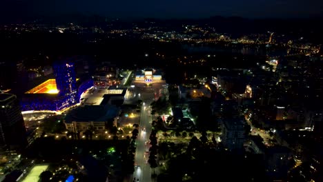 central boulevard of the capital tirana at night with cars moving through illuminated buildings, fantastic drone view of the albanian tourist attraction