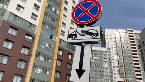 road sign parking prohibited evacuation on the background of modern apartments buildings. modern residential quarter. no parking!