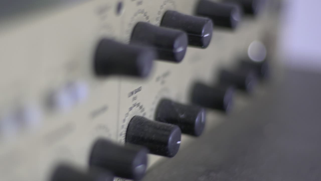 Close up of knobs and switches on a audio recording device