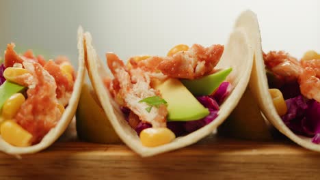 crispy chicken tacos with avocado and cabbage