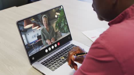 Animation-of-african-american-man-having-video-call-on-laptop