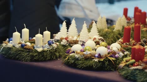 different christmas candles with decoration in store for sell, handheld view