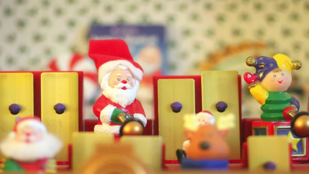 Dorking, England - August 07 2018: Christmas musical box showing Santa Claus and his helpers playing tunes on a toy xylophone. Close up of Santa Claus toy.