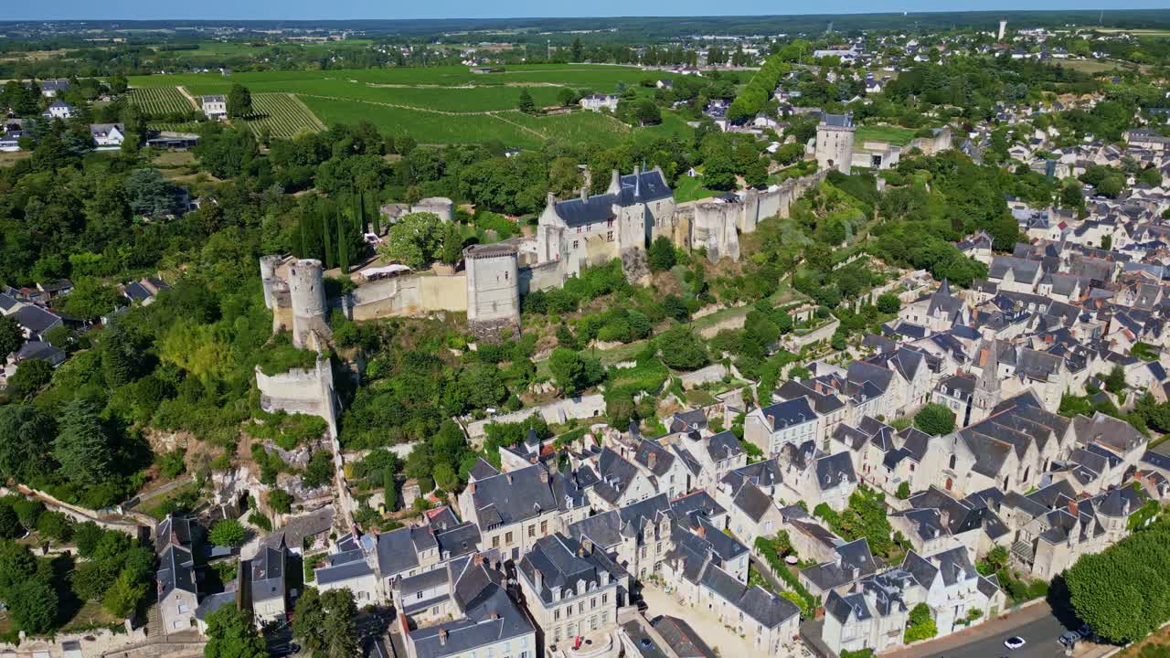 Royal Fortress of Chinon, medieval castle on hill overlooking town and vineyards, Loire Valley, France. Aerial drone view