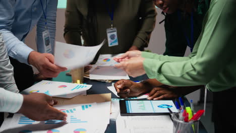 diverse team members meeting after hours to share data reports