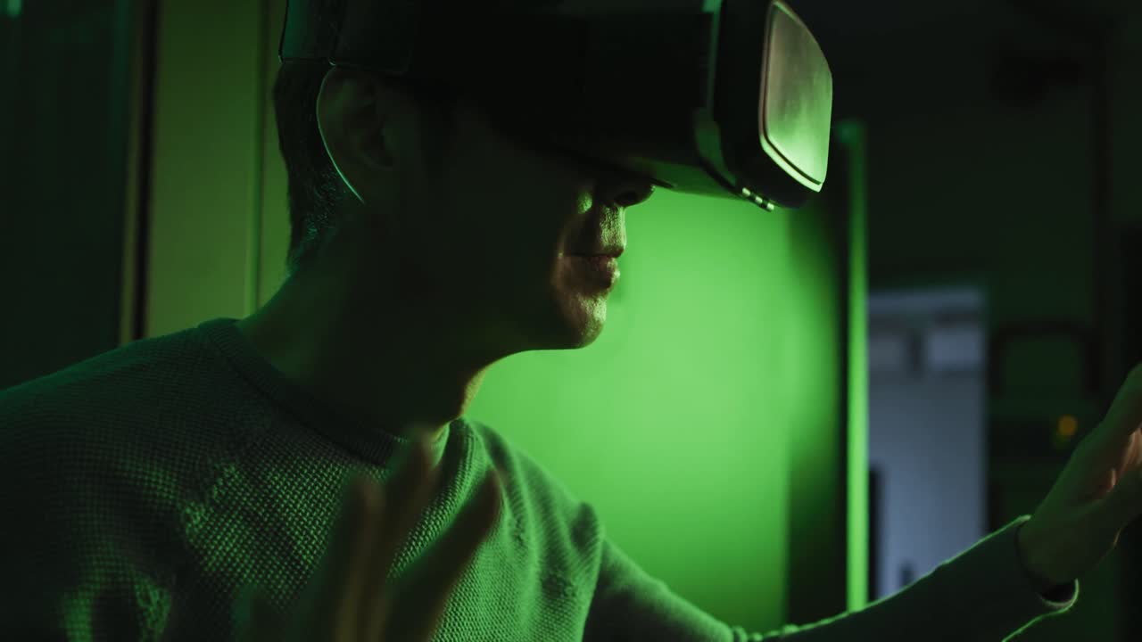 Asian man wearing vr headset by computer server