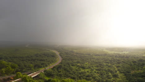 Cars-drive-on-Arizona-highway-through-dramatic-monsoon-rain-storm,-drone-descend