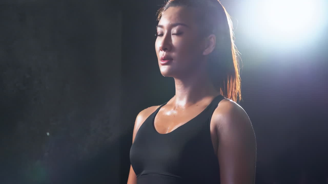 Female athlete attractive woman in sport clothes in gym clapping hands with white powder. Sport, healthy lifestyle, boxing concept