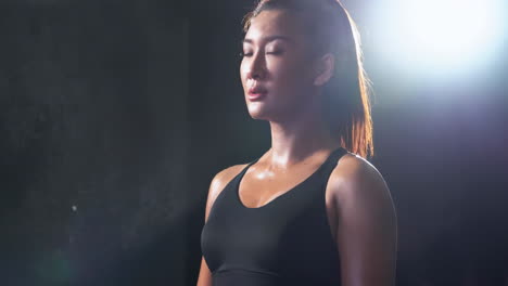 female athlete attractive woman in sport clothes in gym clapping hands with white powder. sport, healthy lifestyle, boxing concept
