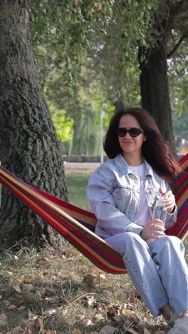 woman relaxing in a hammock in a park