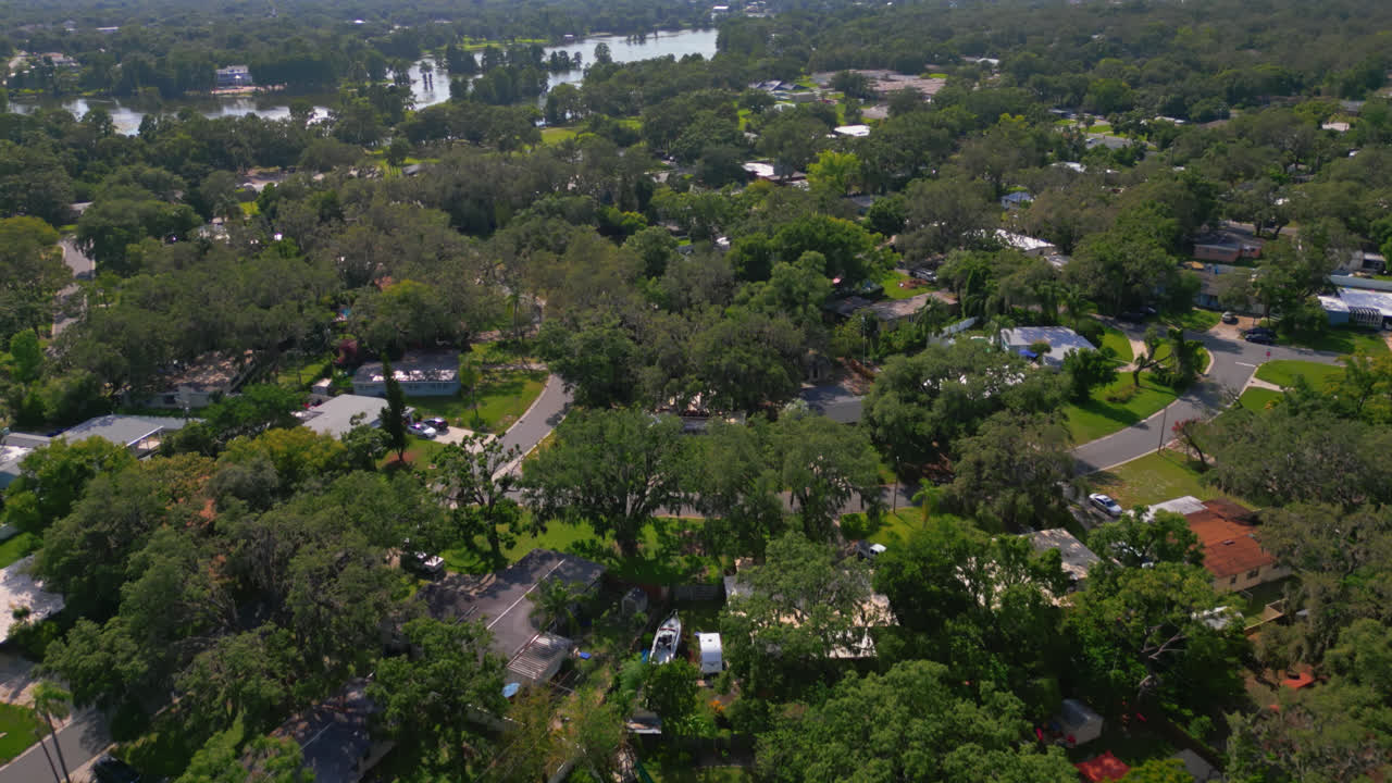 Drone flying over a Tampa suburb neighborhood with the Hillsborough River in the background on a beautiful day